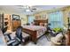 Spacious primary bedroom boasts a ceiling fan, desk and a relaxing sitting area at 10836 Maryanna Ct, Charlotte, NC 28213