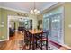 Open-concept dining area featuring hardwood floors, stylish seating, and access to the backyard at 10836 Maryanna Ct, Charlotte, NC 28213