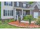 Charming brick-accented home with a cozy front porch and manicured landscaping at 10836 Maryanna Ct, Charlotte, NC 28213