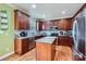 Well-equipped kitchen with stainless steel appliances, granite countertops, and custom wood cabinets at 10836 Maryanna Ct, Charlotte, NC 28213
