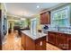 Bright kitchen featuring a center island, stainless steel appliances, and open view to dining area at 10836 Maryanna Ct, Charlotte, NC 28213