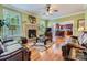 Cozy living room featuring a stone fireplace, hardwood floors, and an open view to the kitchen at 10836 Maryanna Ct, Charlotte, NC 28213