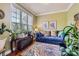 Cozy living room featuring a plush blue sofa, patterned rug, and large window for natural light at 10836 Maryanna Ct, Charlotte, NC 28213