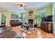 Inviting living room features hardwood floors, cozy fireplace and ceiling fan at 10836 Maryanna Ct, Charlotte, NC 28213