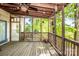 Relaxing screened back porch with ceiling fan, natural wood and nature views at 11024 Hunters Trace None, Charlotte, NC 28262
