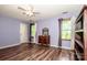 Large bedroom featuring wood floors, neutral walls, and multiple windows for ample light at 11024 Hunters Trace None, Charlotte, NC 28262