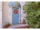 Welcoming front door with wreath and arched window, complemented by mature landscaping at 11024 Hunters Trace None, Charlotte, NC 28262
