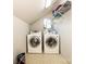 Functional laundry room with modern washer and dryer units and storage shelving at 11024 Hunters Trace None, Charlotte, NC 28262
