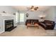 Living room featuring a fireplace, neutral walls, and large windows for ample light at 11024 Hunters Trace None, Charlotte, NC 28262