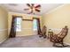 Bright, airy living room with large windows, ceiling fan, and comfortable rocking chairs at 11024 Hunters Trace None, Charlotte, NC 28262