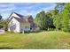 Spacious backyard with lush green lawn, mature trees, and a deck perfect for outdoor living at 1105 Hoyle Ln, Waxhaw, NC 28173