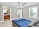 Neutral bedroom featuring a blue bedspread, ceiling fan, and ensuite bathroom at 1105 Hoyle Ln, Waxhaw, NC 28173