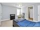 Well-lit bedroom features a ceiling fan, bedside chair, and neutral color scheme at 1105 Hoyle Ln, Waxhaw, NC 28173