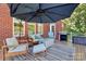 A cozy outdoor patio with outdoor seating, an umbrella, and a grill at 1105 Hoyle Ln, Waxhaw, NC 28173