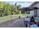 A charming outdoor deck with outdoor seating, a gray rug, and a view of the lush green backyard at 1105 Hoyle Ln, Waxhaw, NC 28173