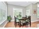 Cozy dining room with a large window, hardwood floors, and a modern table at 1105 Hoyle Ln, Waxhaw, NC 28173