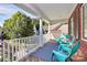 Inviting front porch with blue chairs, white columns, and a beautiful outdoor rug at 1105 Hoyle Ln, Waxhaw, NC 28173