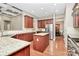 Bright, open kitchen with wooden cabinets, granite countertops, and stainless steel appliances at 1105 Hoyle Ln, Waxhaw, NC 28173