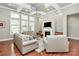 Bright living room boasts high ceilings, a ceiling fan, large windows, a fireplace and comfortable seating at 1105 Hoyle Ln, Waxhaw, NC 28173