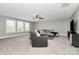 Spacious living area with large windows offering natural light, plush seating, and a modern media console at 1105 Hoyle Ln, Waxhaw, NC 28173
