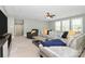 Bright living room with neutral walls, modern ceiling fan, large windows, and comfortable seating at 1105 Hoyle Ln, Waxhaw, NC 28173