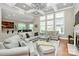 Open-concept living room with hardwood floors, coffered ceiling, fireplace, and abundant natural light at 1105 Hoyle Ln, Waxhaw, NC 28173