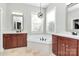 Luxury main bathroom features a corner tub, vanities and decorative light fixture at 1105 Hoyle Ln, Waxhaw, NC 28173