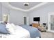 Serene main bedroom features tray ceiling, carpet, dresser, chair, and natural light at 1105 Hoyle Ln, Waxhaw, NC 28173