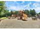 A community playground with slides, climbing structures, and a wood chip ground cover at 1105 Hoyle Ln, Waxhaw, NC 28173