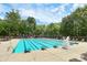 A beautiful community swimming pool with lap lanes and lounge chairs, surrounded by lush greenery and trees at 1105 Hoyle Ln, Waxhaw, NC 28173