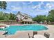 A beautiful community pool with a water slide, a playground, and a large building in the background at 1105 Hoyle Ln, Waxhaw, NC 28173