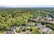 Expansive aerial view of a residential area with homes, green spaces, a pool, and mature trees, offering a serene setting at 1119 21St Ne Ave, Hickory, NC 28601