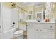 Well-lit bathroom featuring a white vanity, toilet, shower-tub combo, and a large mirror reflecting the clean space at 1119 21St Ne Ave, Hickory, NC 28601