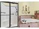 Relaxing bathroom featuring a soaking tub, a glass enclosed shower, and decorative tile accents at 1119 21St Ne Ave, Hickory, NC 28601