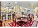 Dining area with decorative rug, table, chairs, and bar seating leading to the kitchen at 1119 21St Ne Ave, Hickory, NC 28601