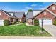 Charming brick home featuring manicured lawn and lush landscaping with a two-car garage and inviting entryway at 1119 21St Ne Ave, Hickory, NC 28601