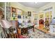 Bright office featuring unique decor, art, and a glimpse into a cozy living room with a fireplace at 1119 21St Ne Ave, Hickory, NC 28601