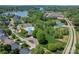 Scenic aerial view of community amenities including a pool, playground, tennis courts, and lake access at 112 Serravista St, Mooresville, NC 28117
