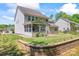 Landscaped backyard with retaining wall and screened in porch at 112 Serravista St, Mooresville, NC 28117