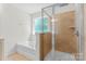 Bathroom featuring tile shower, soaking tub, and natural light from the window at 112 Serravista St, Mooresville, NC 28117