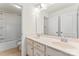 Bright bathroom featuring a double vanity, large mirror, and shower-tub combination at 112 Serravista St, Mooresville, NC 28117