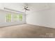 Spacious bedroom featuring three large windows for natural light and a ceiling fan at 112 Serravista St, Mooresville, NC 28117