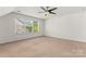 Bright bedroom features large windows, neutral carpet and a ceiling fan at 112 Serravista St, Mooresville, NC 28117