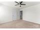 Bedroom has neutral walls, carpet flooring, a ceiling fan, and a doorway to a closet at 112 Serravista St, Mooresville, NC 28117