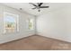 Bedroom featuring a fan, carpet, and window at 112 Serravista St, Mooresville, NC 28117