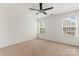 Bedroom has neutral walls, two windows, and carpet flooring and a ceiling fan at 112 Serravista St, Mooresville, NC 28117