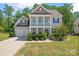 Beautiful two-story home with a spacious front yard, manicured bushes, and a two-car garage at 112 Serravista St, Mooresville, NC 28117