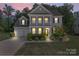 Charming two-story home features a welcoming porch, well-maintained landscaping, and a two-car garage at 112 Serravista St, Mooresville, NC 28117