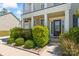 Inviting front entrance with manicured landscaping, stylish door, and a charming porch at 112 Serravista St, Mooresville, NC 28117