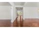 Inviting hallway with gleaming wood floors, white trim, and views into other rooms, creating a sense of spaciousness at 112 Serravista St, Mooresville, NC 28117